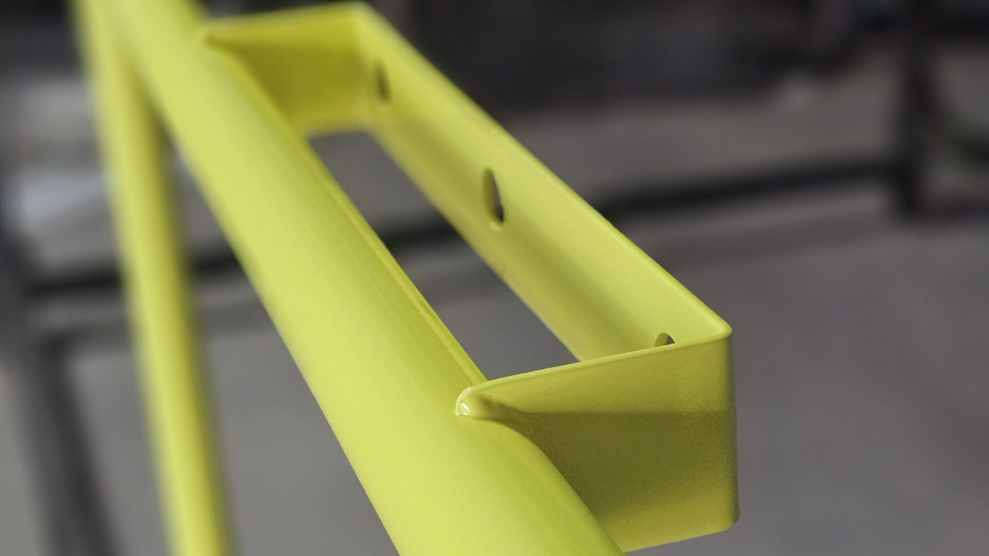 Freshly powder coated chartreuse handrail, gloss finish, in the Indigo Industries shop